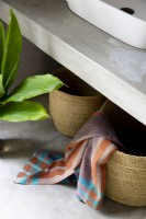 Woven storage baskets beneath bathroom vanity