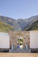 Mountain views behind stone entrance with antique door