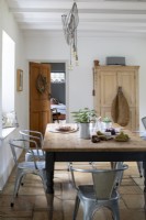 Sally and John Biddle's house in Cornwall, country kitchen, with whitewashed walls and beams. Large kitchen table