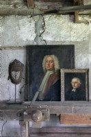 Antique portrait paintings on old wooden workbench