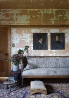 Portrait paintings on distressed country living room wall