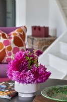 Bright pink and purple flowers on coffee table - detail