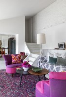 Pink and purple chairs in eclectic living room