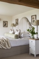 Large upholstered headboard in classic style bedroom