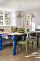Blue and green painted furniture in country dining room