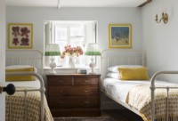 Vintage furniture in country bedroom with twin metal framed beds 