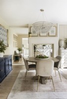 Chandelier over round dining table in classic dining room