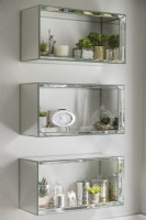 Wall mounted mirrored shelves in modern bathroom