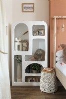 Unusual molded shelf unit in modern bedroom