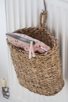 Detail of small pink makeup bag in suspended basket