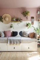 Daybed sofa surrounded by houseplants