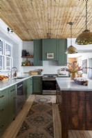 Country kitchen with green cabinets and wooden ceiling