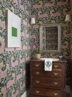 Powder room with bureau sink basin and tiger wall paper