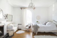 White country bedroom with vintage furniture and wooden flooring