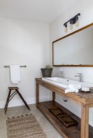 Repurposed wooden table as sink unit in country bathroom
