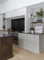 Modern country style kitchen with large range cooker in fireplace