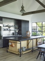 Contemporary kitchen with black stone island and stainless steel sheves
