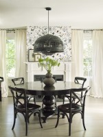 Dining room with fireplace and black table and chairs
