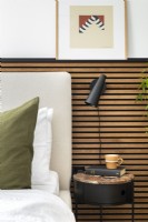 Upholstered headboard with slatted wall paneling.