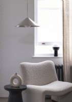 Modern Boucle armchair in front of a sash window