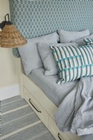 Detail of built in bed with upholstered headboard.