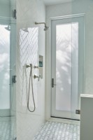 A tiled shower with out door access.