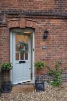 Christmas wreath on green grey traditional front door