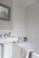 Classic white bathroom with grey painted mirror