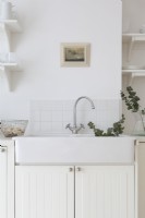 White ceramic sink in scan style white kitchen