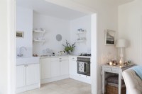 Bright classic white kitchen from open plan dining room