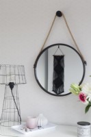 Dressing table detail with round mirror and macrame wall hanging