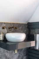 Detail of white sink with grey marble hexagon tiles