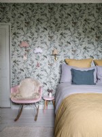 Bedroom with tropical bird wallpaper and rocking chair
