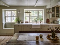 Neutral country kitchen with butler sink and pendant lighting