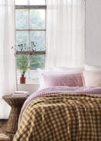 Pink gingham bedlinen with checked throw
