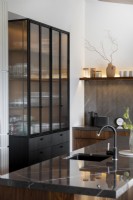 Fluted glass cabinet in kitchen with walnut detailing