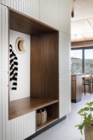 Mudroom cabinet featuring walnut clad niche