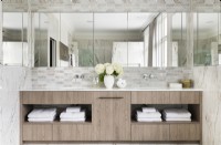 Contemporary, classic large double vanity unit with marble tiles and recessed mirror.