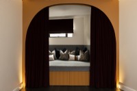 Contemporary modern day bed with storage and arch curtain divider.