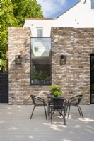 Modern contemporary exterior of brick extension with large wall to ceiling sky light window.