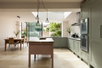 Classic contemporary large kitchen with free standing pink island and views into the garden.
