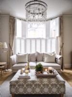 Neutral living room with chandelier 