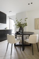 Dining table and chairs in an open plan kitchen diner