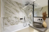 Modern bathroom with marble walls and black fittings